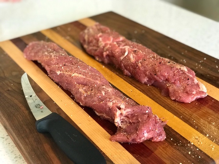 Pork tenderloins trimmed and seasoned.