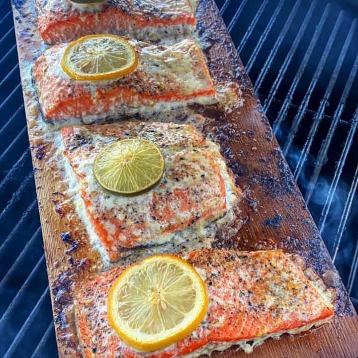 cedar planked salmon on the grill with some citrus.