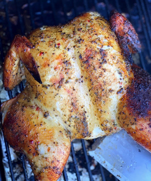 Zesty Grilled Spatchcock chicken coming off the grill.