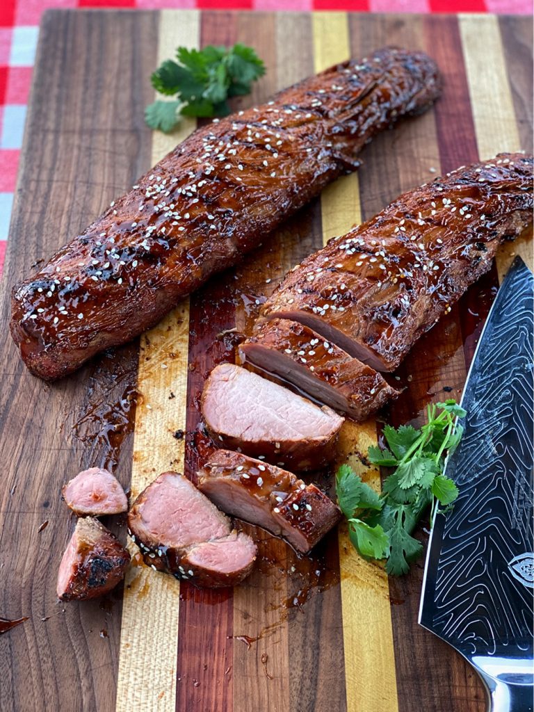 Smoked Teriyaki Pork Tenderloin sliced on the cutting board.