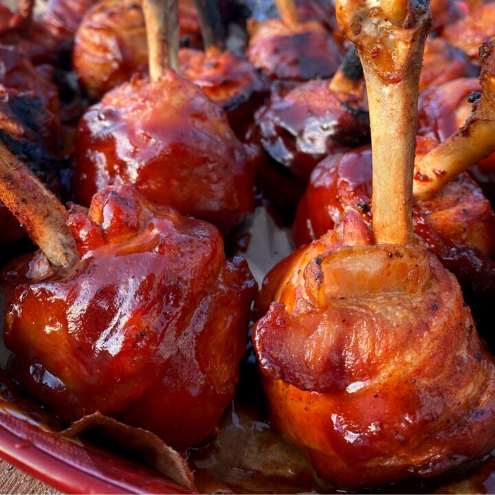 BBQ Chicken Lollipops wrapped in bacon and sauced.