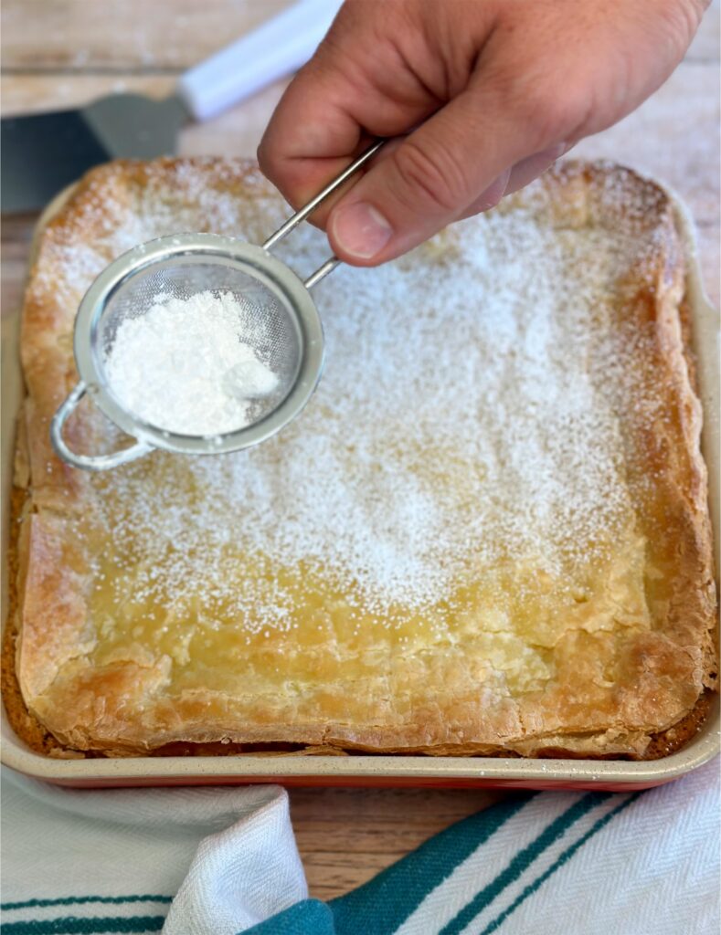 Topping with powdered sugar is a pro move for how to make gooey butter cake. 