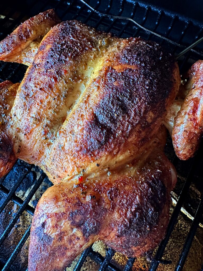 Smoked spatchcock chicken on the grill.