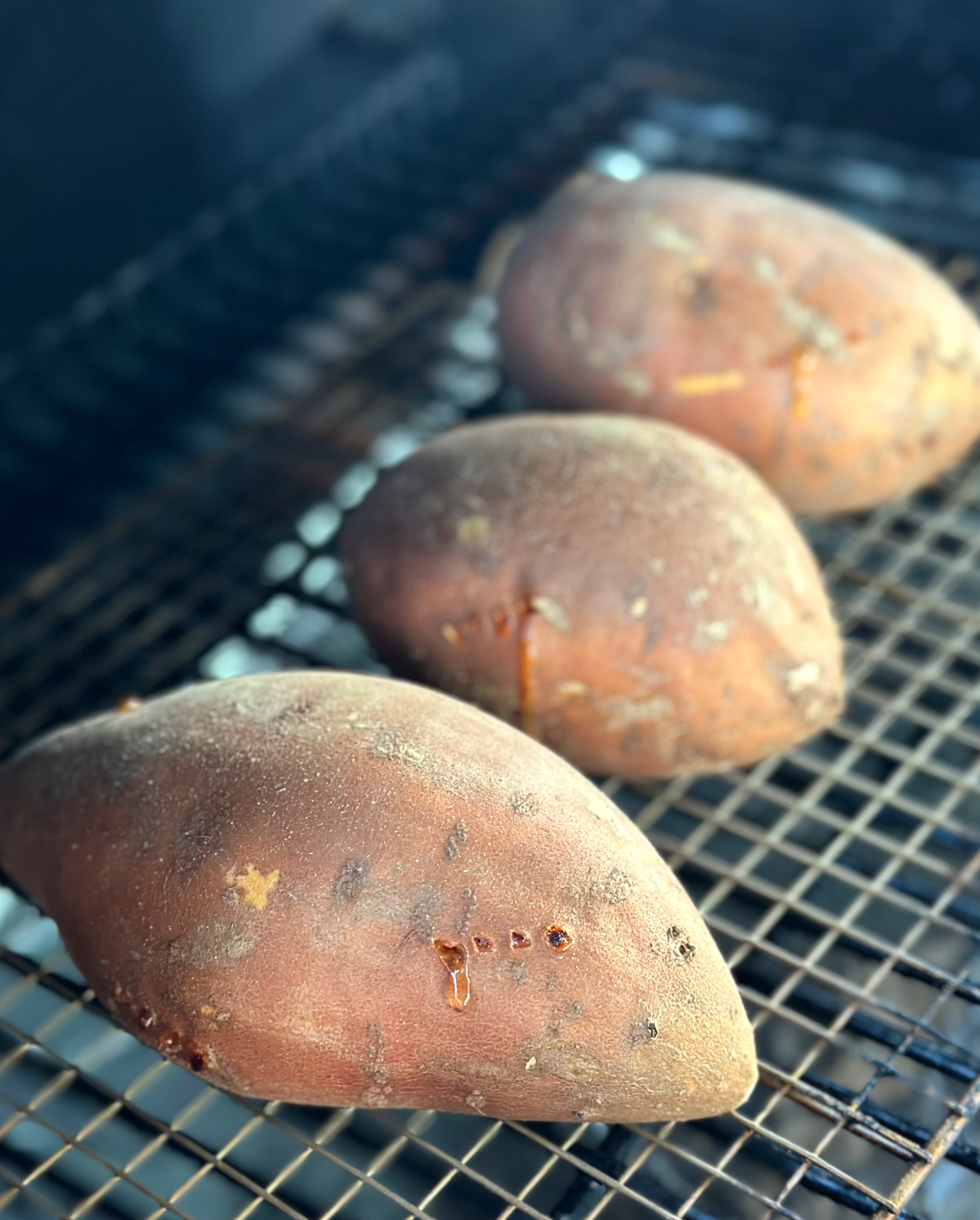 Baked sweet potatoes on the grill with holes poked in them to avoid splitting. 